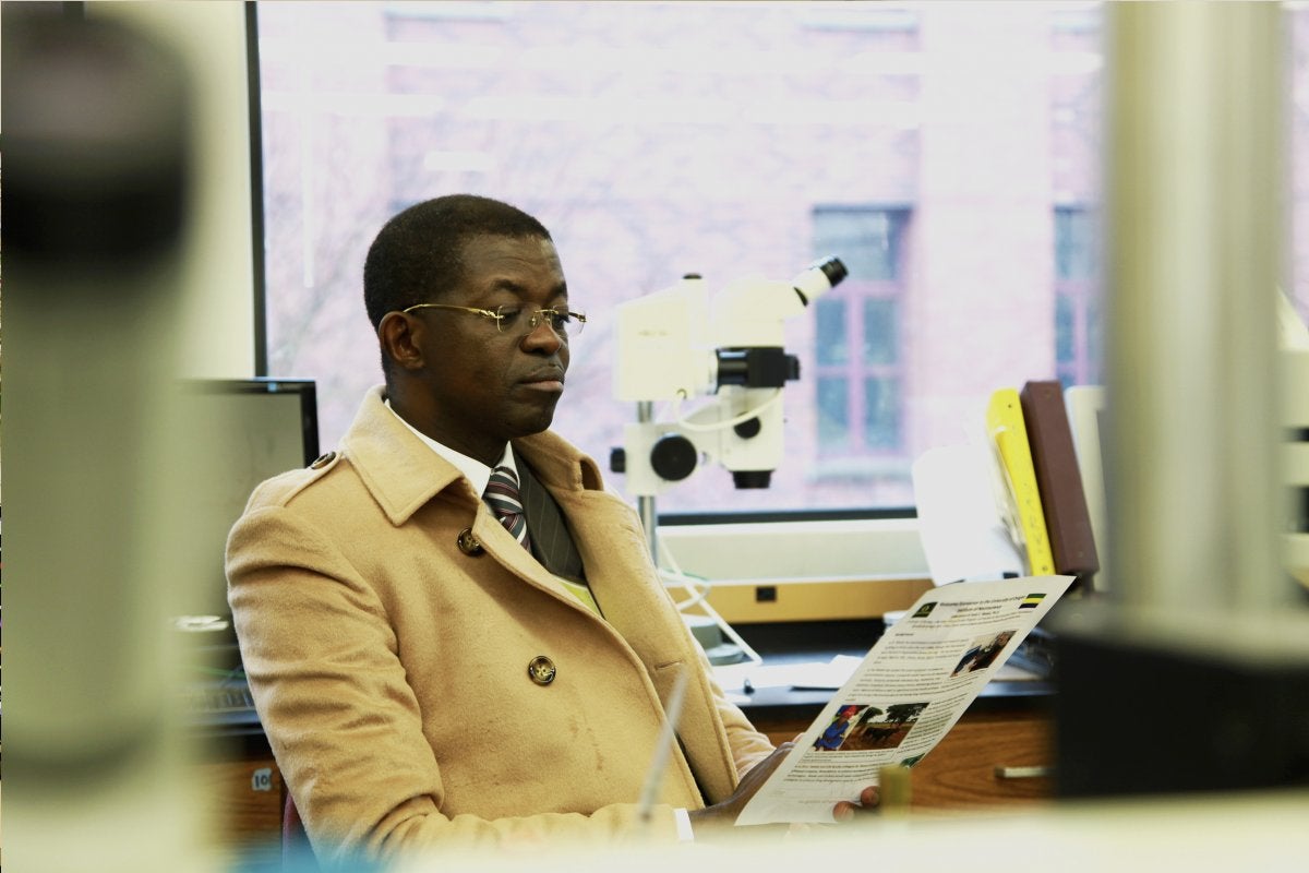 Gabon Education Minister Seraphin Moundounga at the lab of UO biology professor Janis Weeks