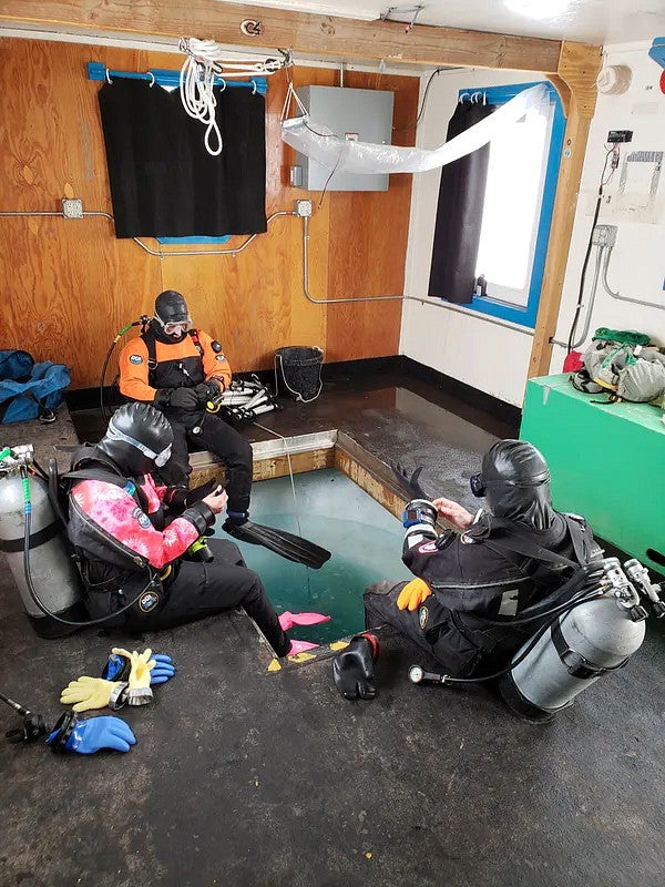 Divers inside shelter hut 