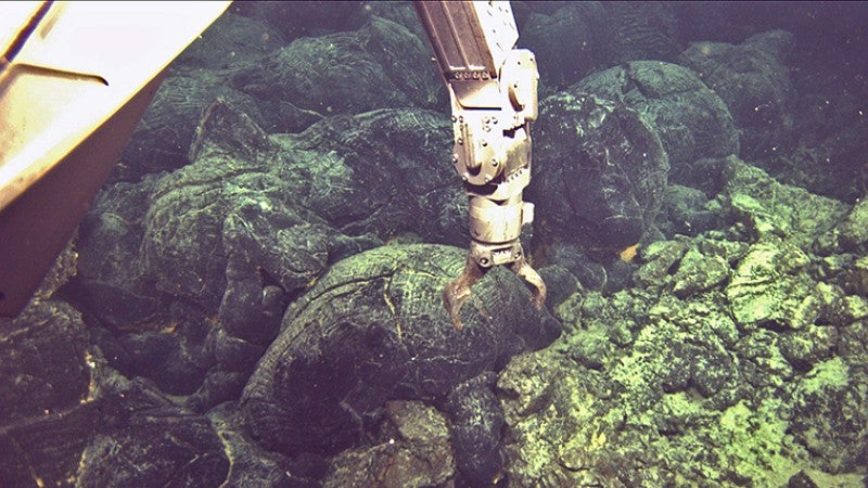 Image shows arm of the remotely operated vehicle Jason preparing to gather lava off seafloor after 2011 eruption off the Oregon coast