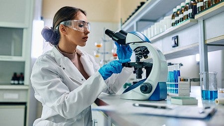 Woman scientist using microscope