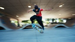 A teenager doing tricks on a skateboard