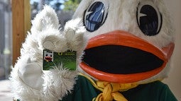 Oregon Duck holding UO ID card