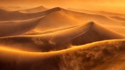 Photo of wind on sand dunes