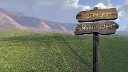 Road signs reading Economy and Environment