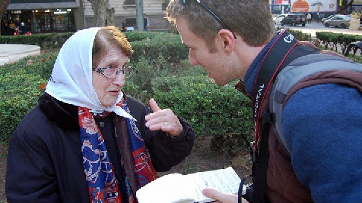 SOJC student Christian Hartwell interviewing a protester in Argentina.
