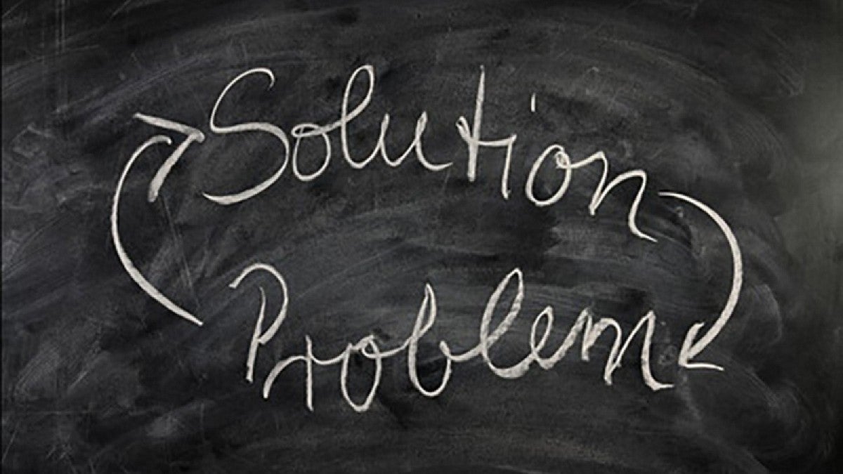 Blackboard with words 'solution' and 'problem'