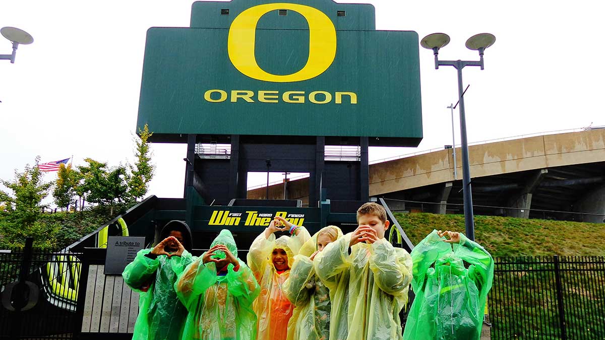 Young students in front of the O at Autzen Stadium