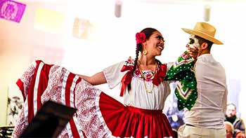 Two people dancing on Día de los Muertos