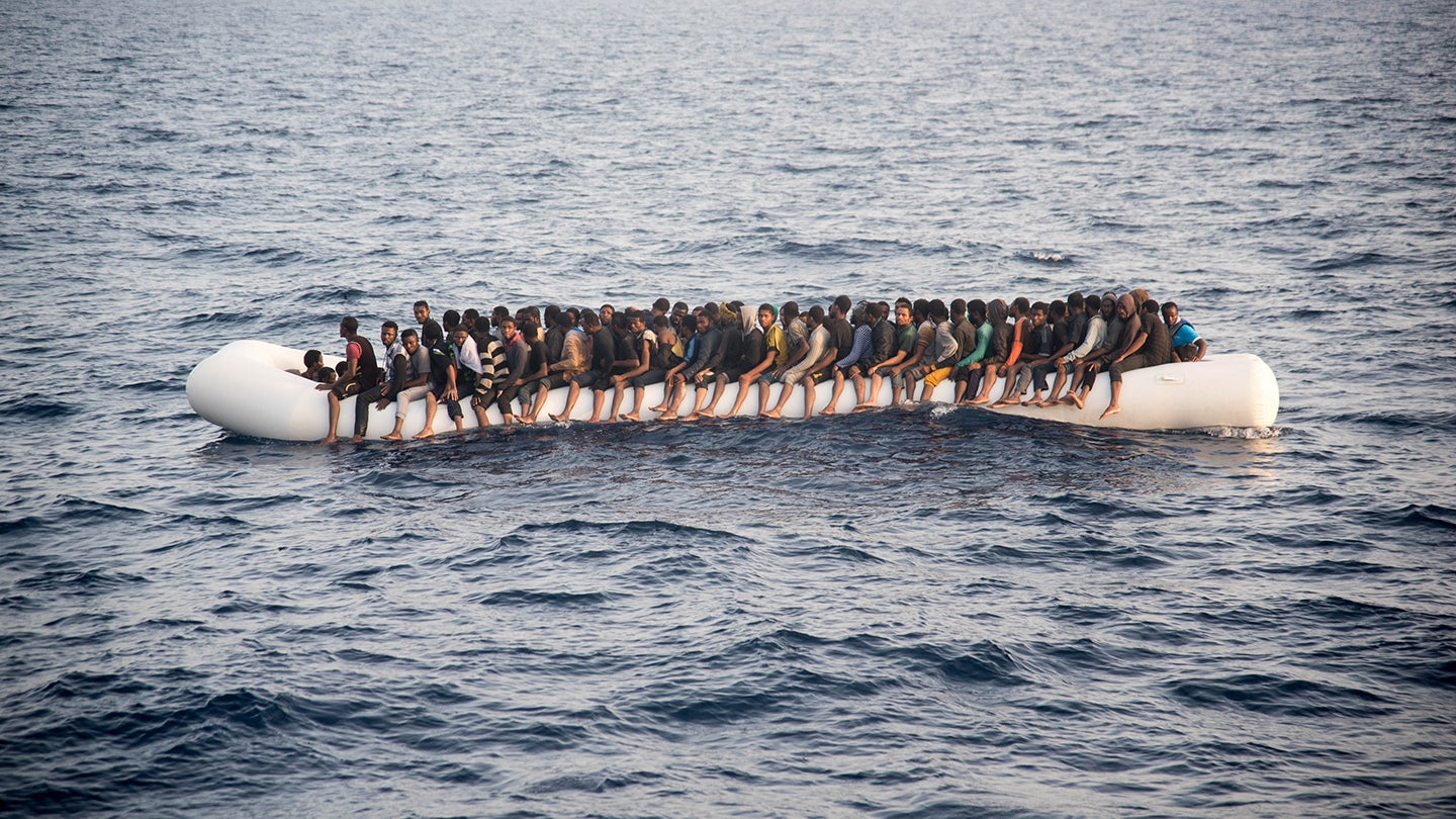 Photo of a lifeboat crowded with refugees off the coast of Libya from the movie Lifeboat (2019)