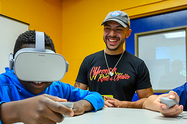 Danny Pimentel oversees a student wearing a VR headset