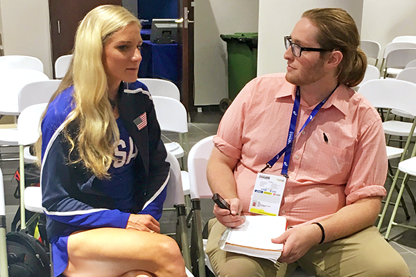a student journalist interviews a USA track and field athlete