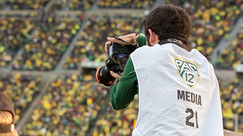 Justin Hartney shooting photos at an Oregon football game