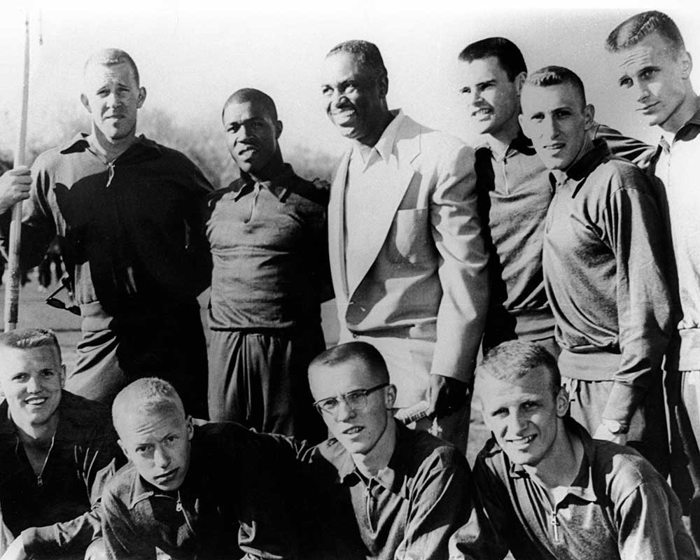 Former University of Oregon sprinter and Olympian Mack Robinson with nine members of the 1959 Duck track and field team, including Phil Knight (front row, second from left), at Hayward Field.  