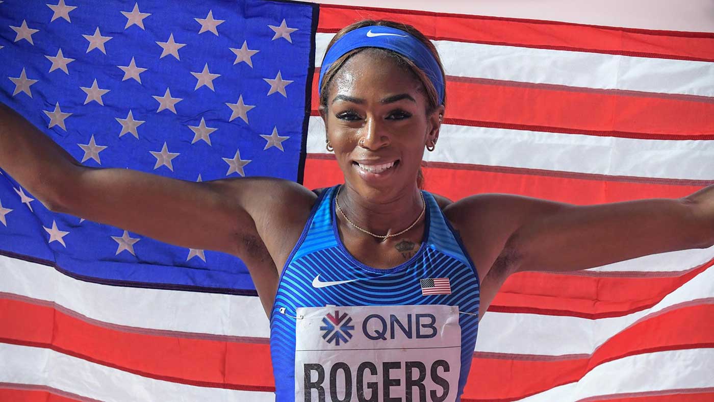 Raevyn Rogers holding up an American flag