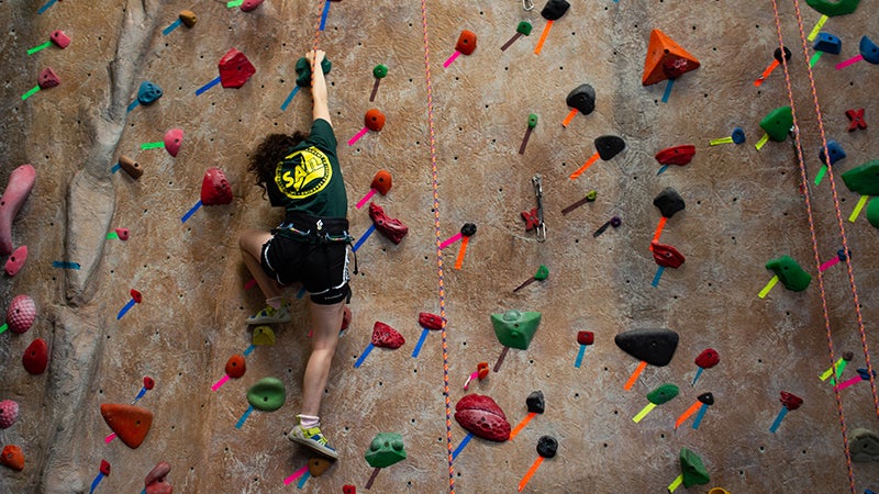 SAIL participant climbs the Rec Center's rock wall