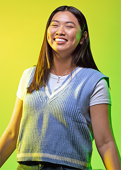 Sally Nguyen pictured in front of a vivid yellow background