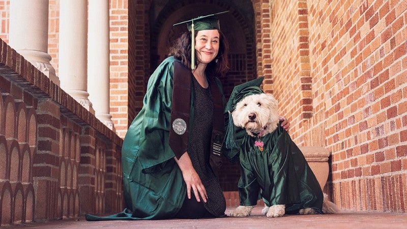 Debbie Williamson Smith and her dog, Pippa, in graduation gear