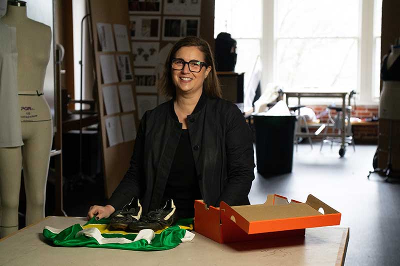 Susan Sokolowski with an open shoe box in a sports product design studio