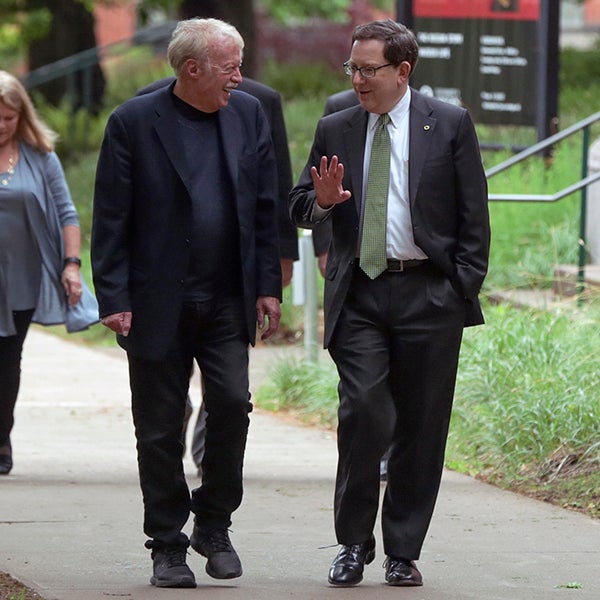 Phil Knight walking with President Michael Schill