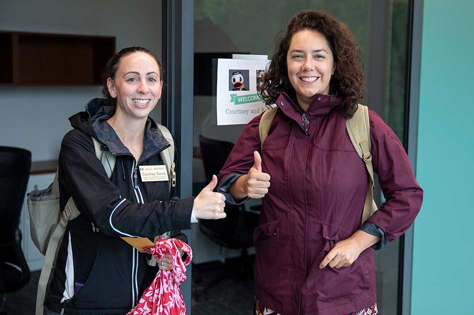 Advisors giving the thumbs up sign during move-in day at Tykeson Hall
