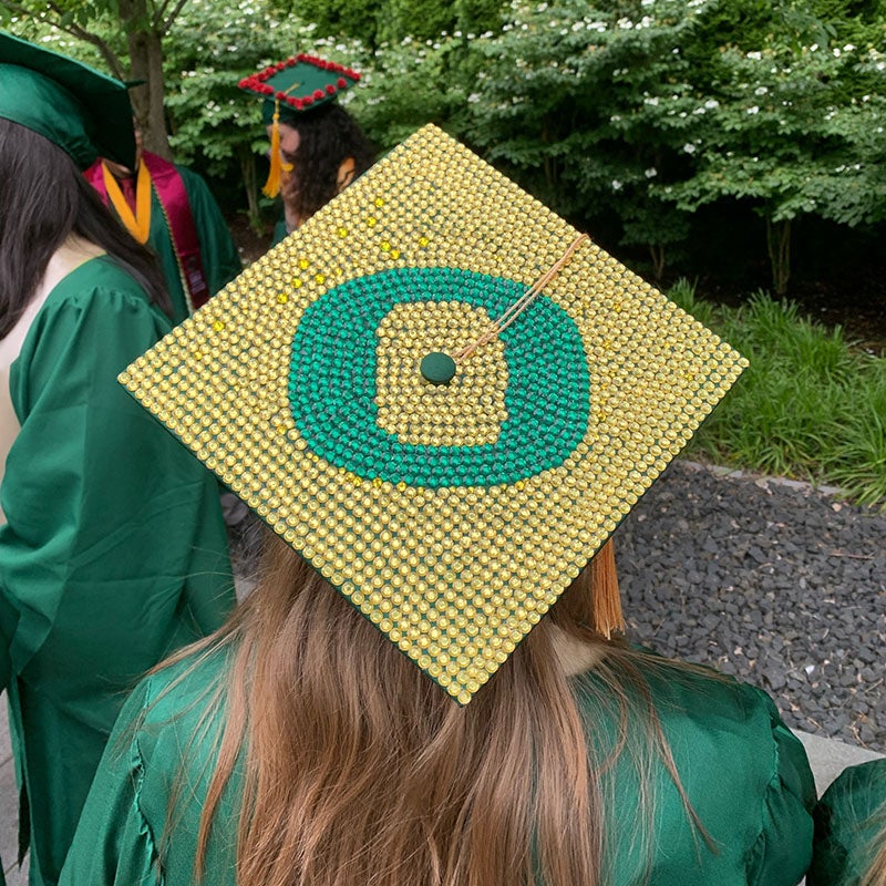 2022 UO Grad caps - UO 'O' in green and yellow