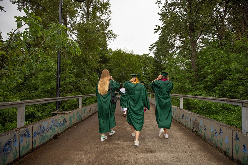 Students walking to Autzen stadium for the 2022 UO graduation