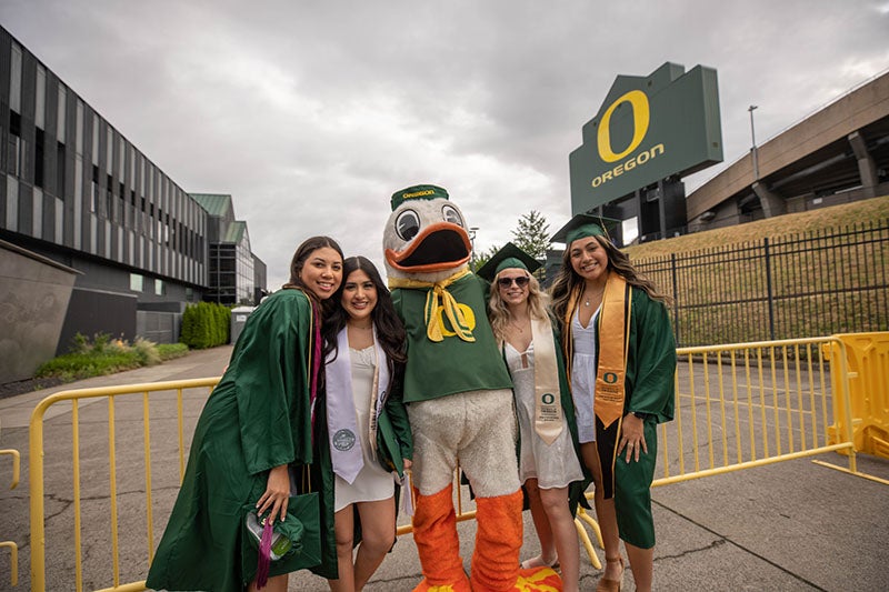 Students with The Duck at the 2022 UO graduation at Autzen Stadium