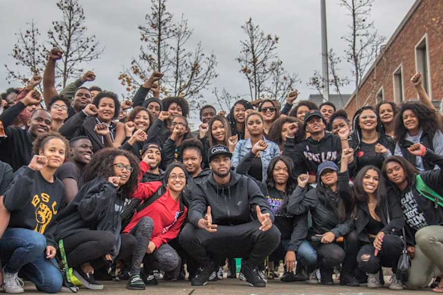 Students raising their fists during the Black Community Rally in the EMU amphitheater on Nov.11, 2016