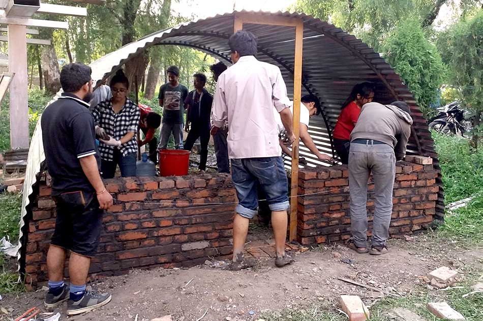 The Aashraya team building an emergency shelter
