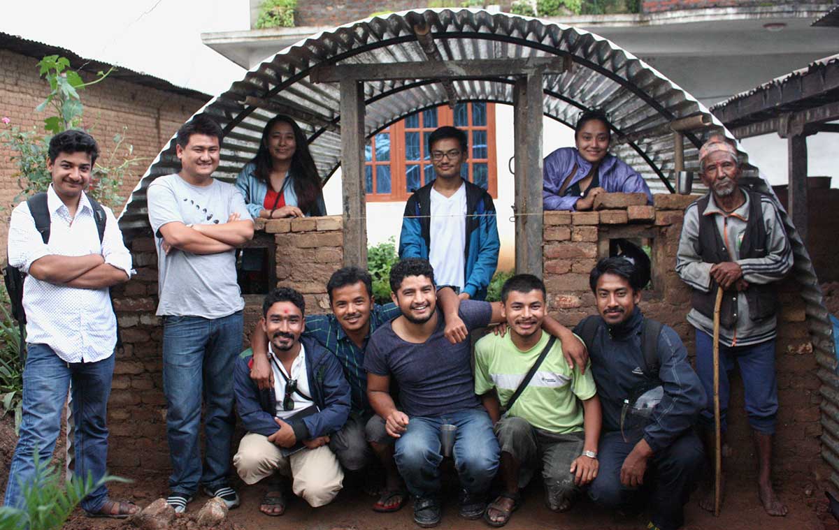 The Aashraya team with a finished emergency shelter