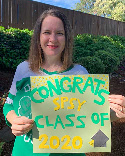 Angie Whalen with a sign that says Congrats SPSY Class of 2020