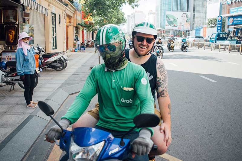 NW Stories student Jeff Dean gets a ride on one of Ho Chi Minh City’s ubiquitous motorcycles.