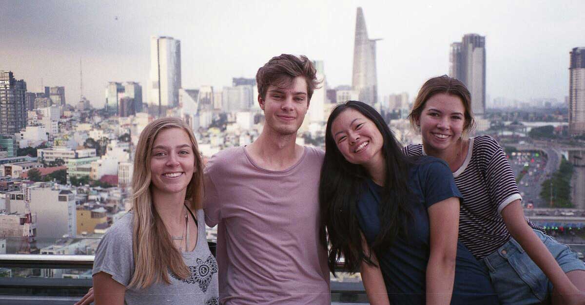 Seven SOJC students in this year’s NW Stories cohort traveled to Vietnam over the summer. From left to right, K.J. Hellis, Ty Boespflug, Kaylee Domzalski, and Cheyenne Thorpe pose in front of a rooftop view of Ho Chi Minh City.