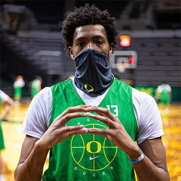 Chandler Lawson wearing a mask and throwing the O