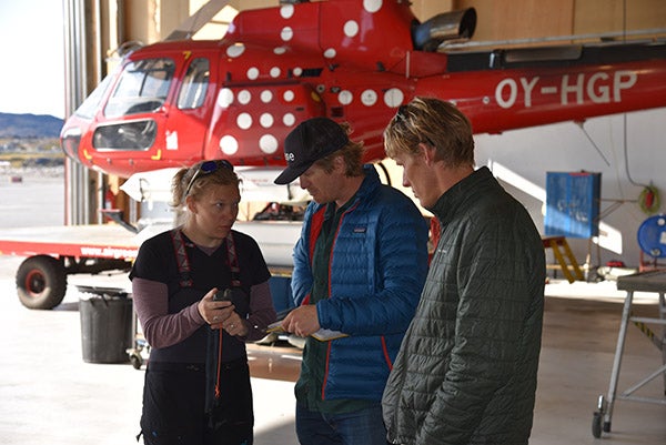 Kristin Schild, Casey Shoop, and Dave Sutherland in front of a helicopter