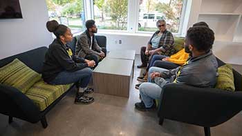 Students speaking with Lyllye Reynolds-Parker in the Black Cultural Center named for her