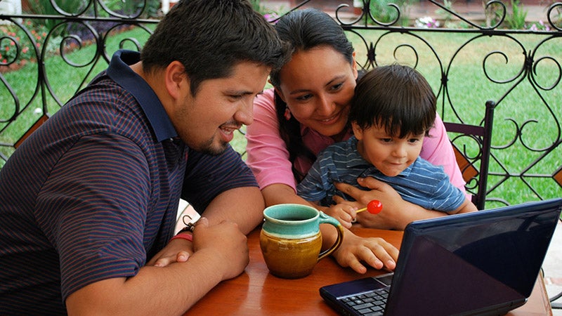 A family looking at a laptop