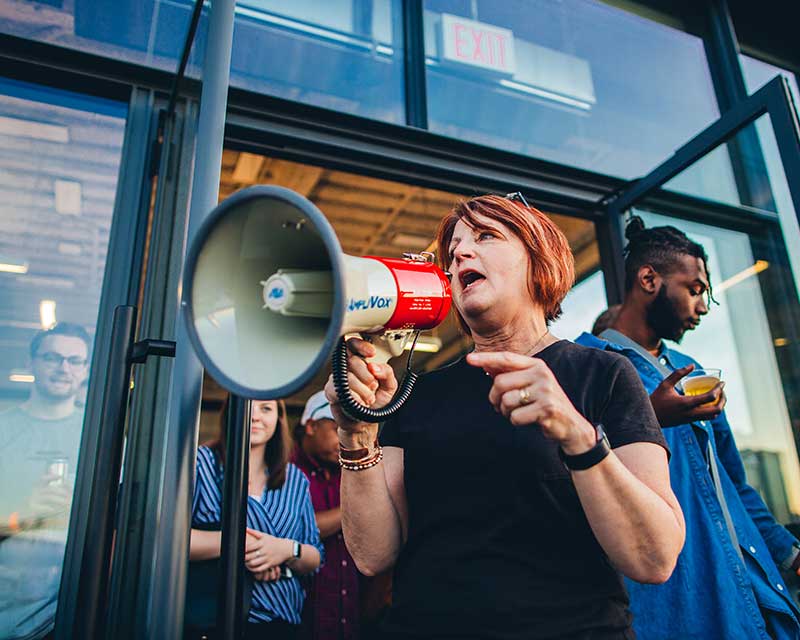 University of Oregon School of Journalism and Communications Professor Deb Morrison wrangles students with a bullhorn during the annual New York advertiting trip