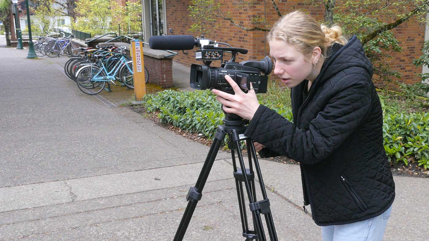 Emily Robinson working with a video camera