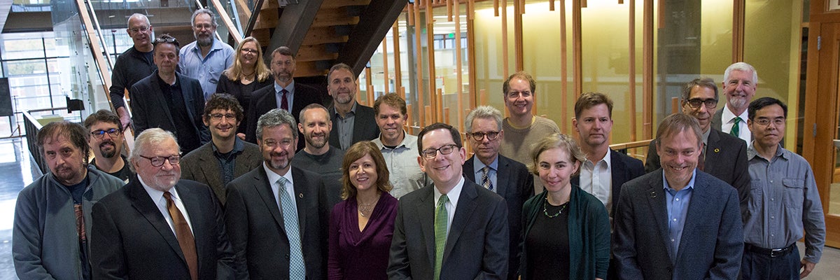 Group photo of faculty members with President Michael Schill and Board of Trustees Chair Chuck Lillis