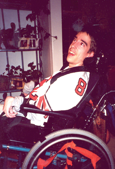 Danny, a bit older, in his wheelchair