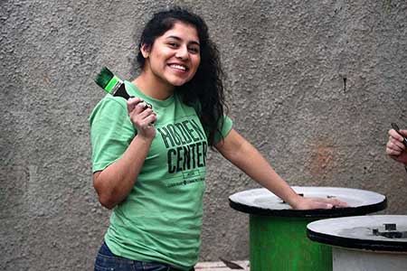 UO student painting stoves during Alt Break in Guatemala