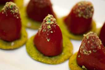 Crushed wasabi peas add crunch and color to crayfish-stuffed piquillo peppers on nettle crackers.