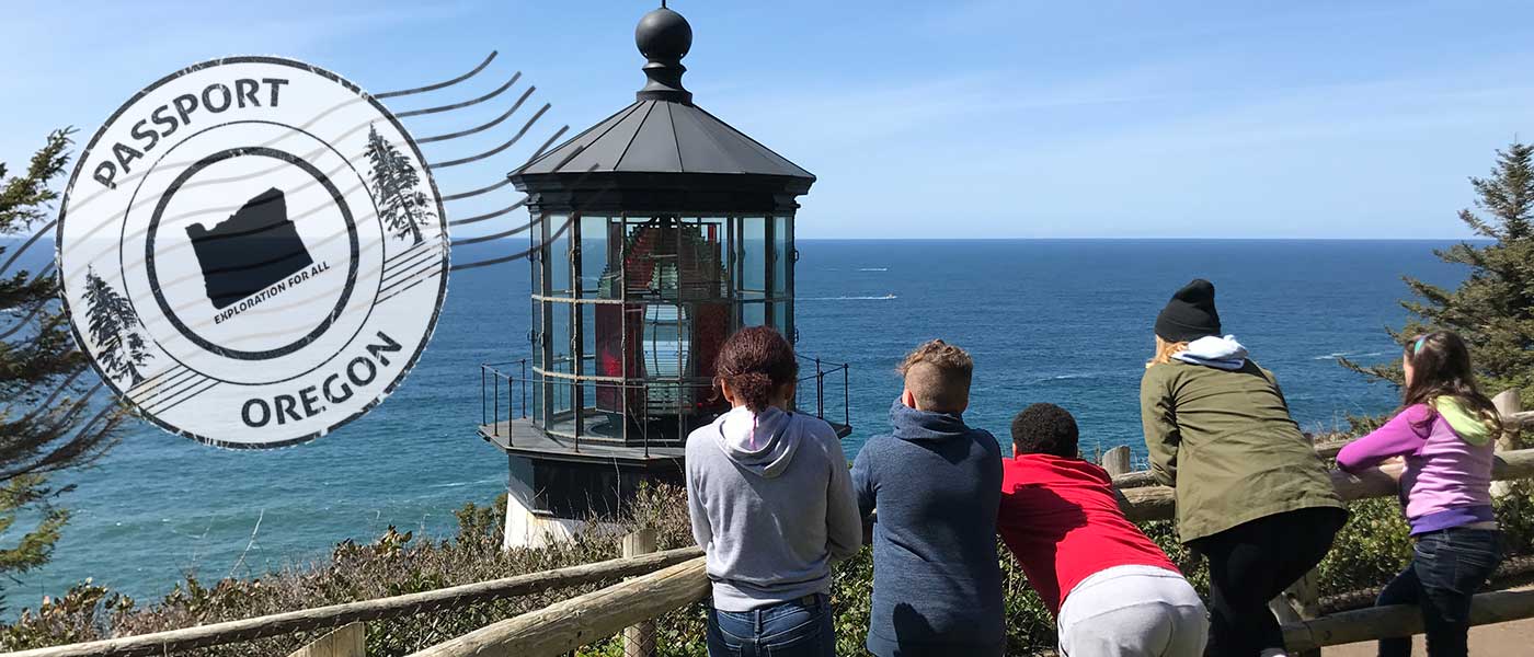 Students from Creston Elementary School looking past a lighthouse at the Pacific Ocean