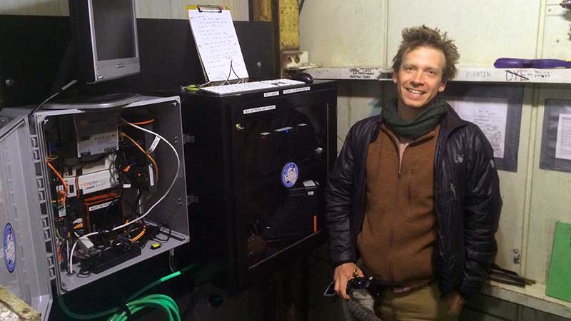 Paul Cziko in front of McMurdo Oceanographic Observatory electronics