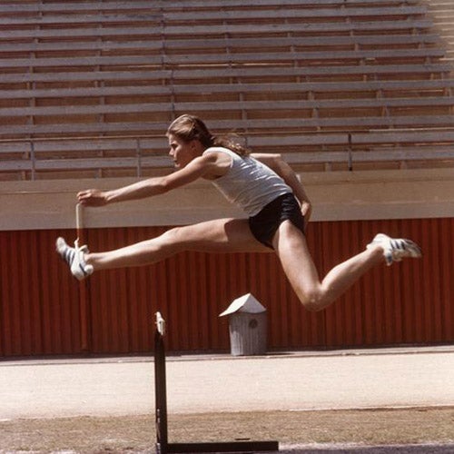 Woman jumping over a hurdle.  Photo courtesy of Oregon Digital