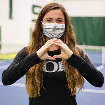Paiton Wagner wearing a mask and throwing the O