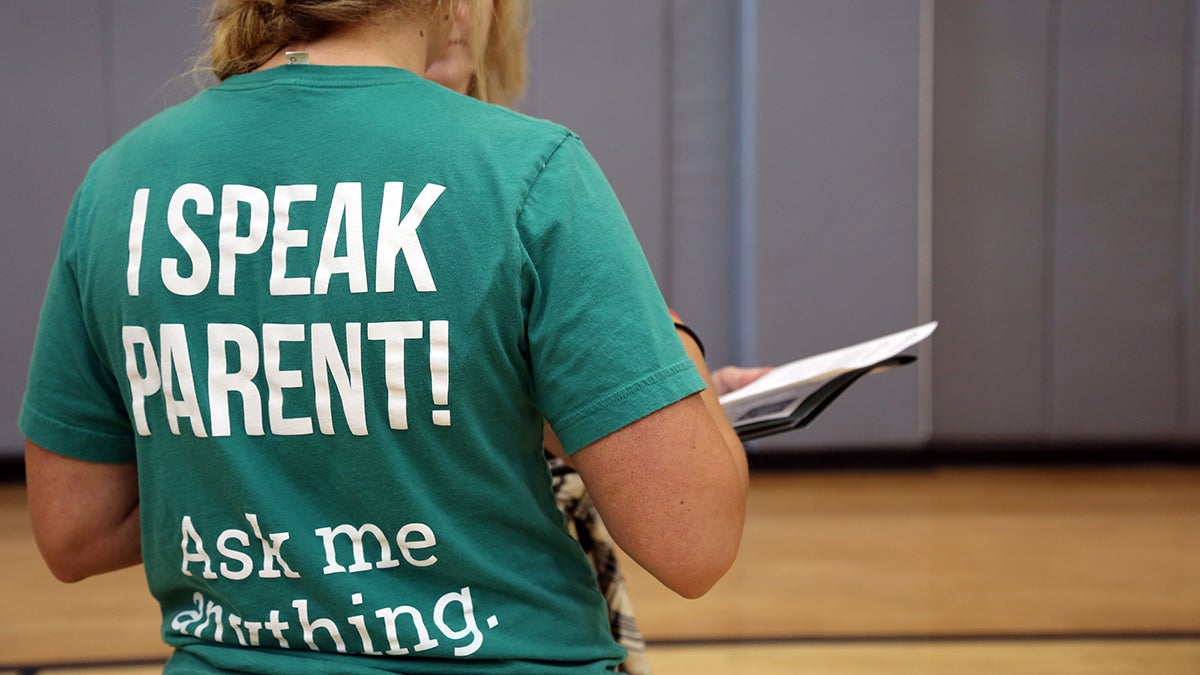 A staff member at IntroDUCKtion wearing a shirt reading I Speak Parent