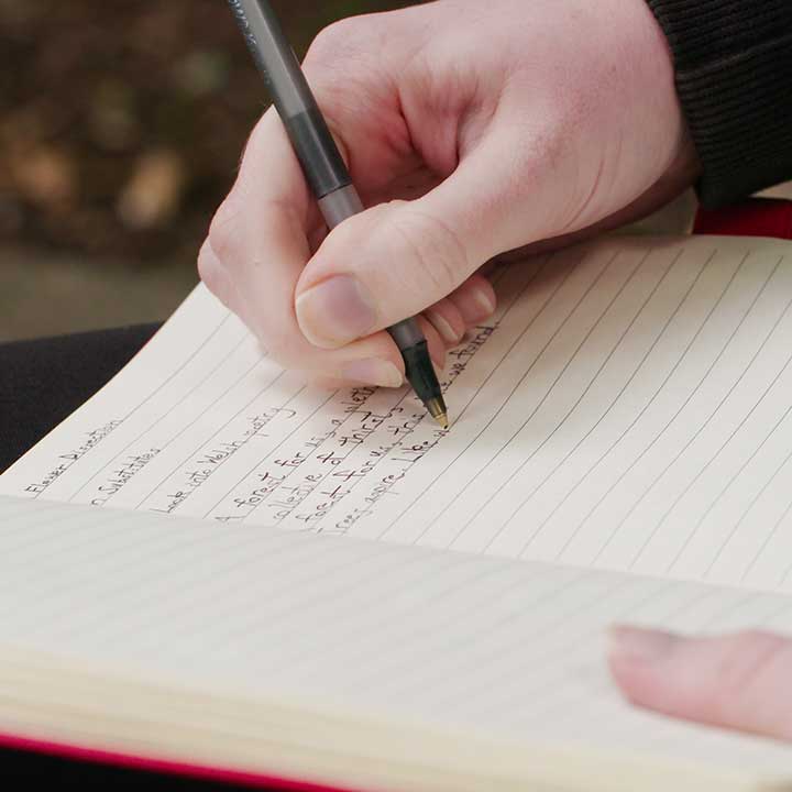 Sarah Hovet writing in her notebook