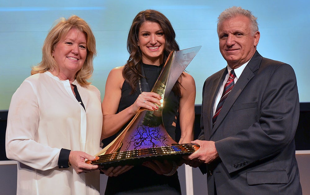 Jenna Prandini with the Bowerman Trophy and her parents 